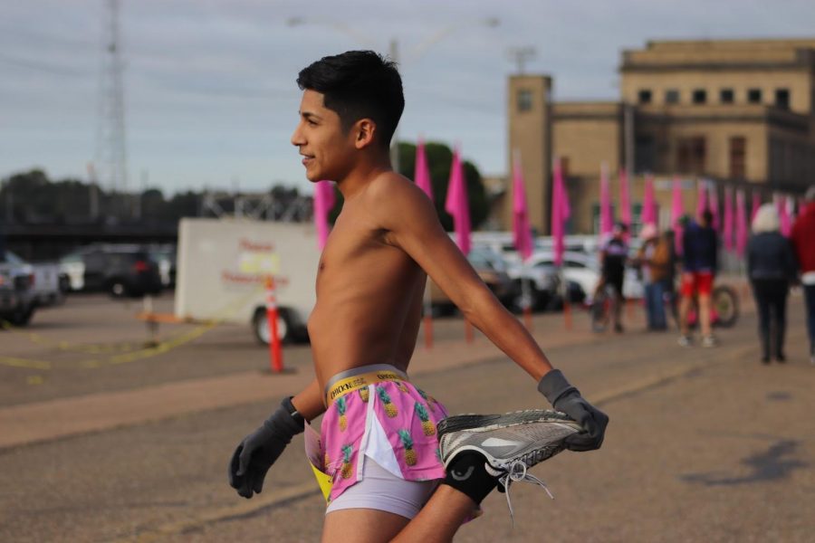 Sophomore Emiliano “Elmo” Mejia stretching before the race.