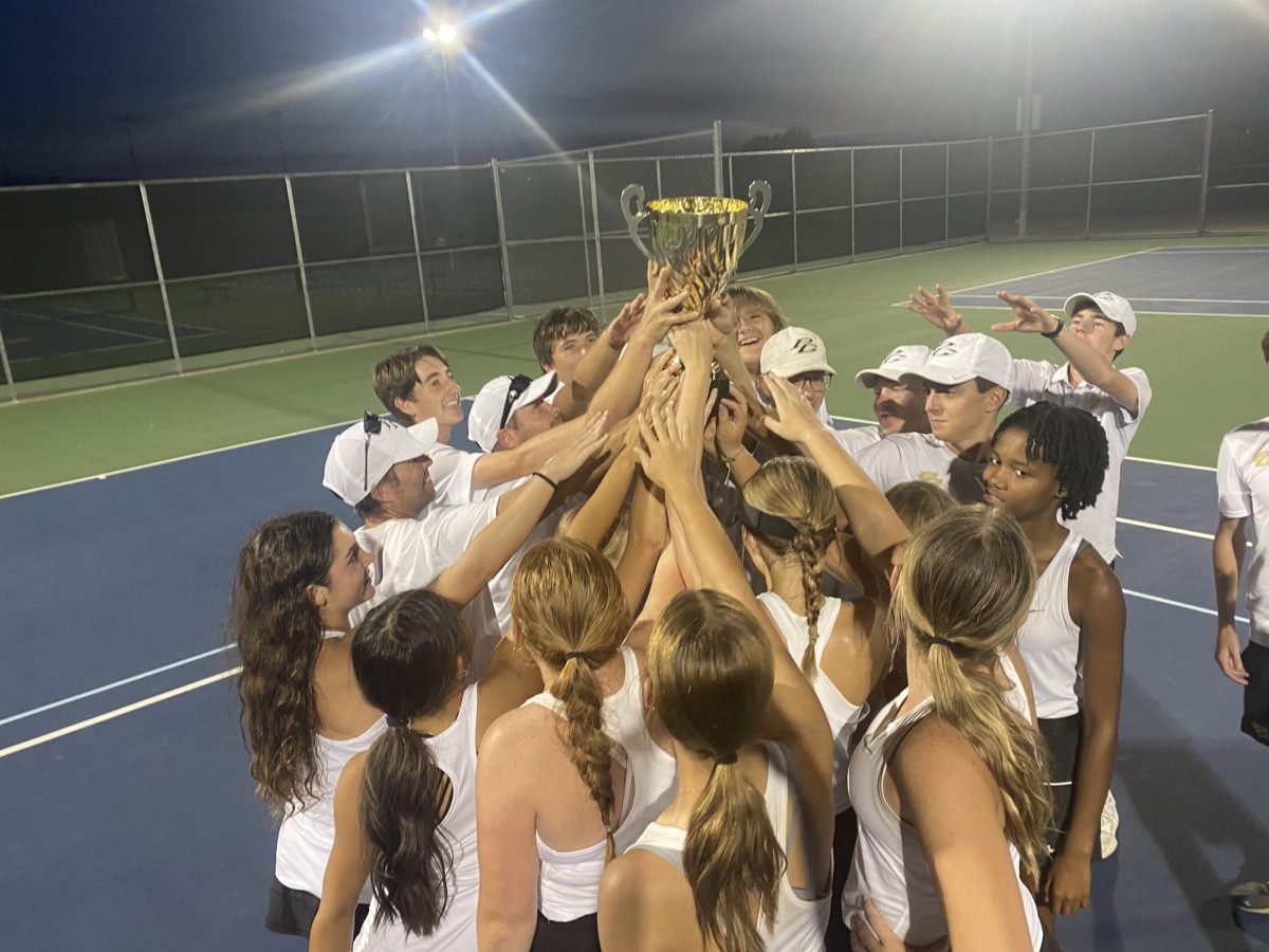 Hawks varsity tennis team celebrates after beating Jacksonville 10-0 at Hallsville on October 9th. 