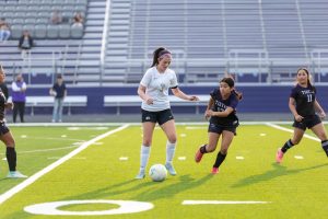 With the ball at her feet, senior Addisyn Gildon looks down at the ball during the game vs the Mount Vernon Tigers. 