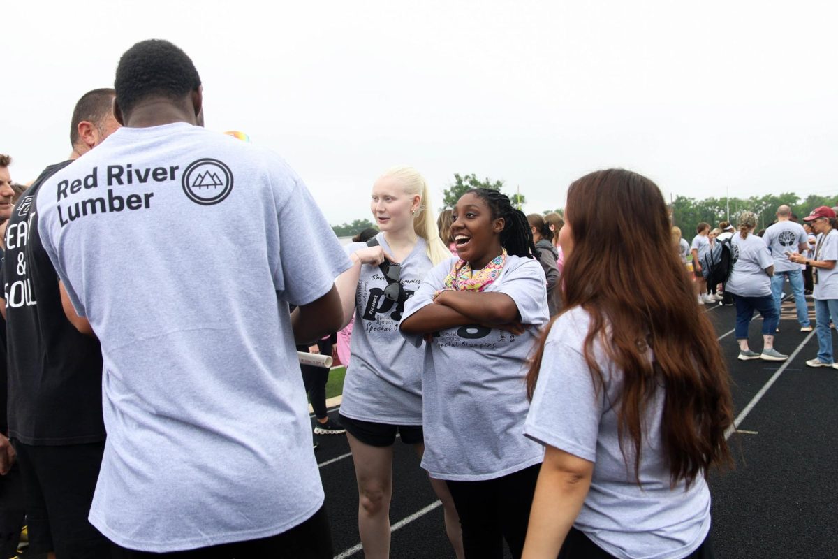 With a smile on her face, junior Olivia Miller laughs at coach Jonathan Darby's joke.