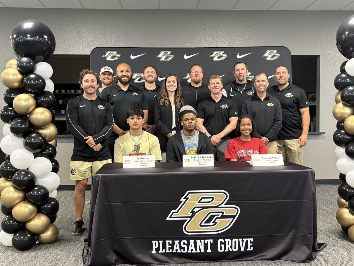 Seniors Ty Boozer, BJ Rochelle, and Lauren Walker sign with their chosen colleges at the signing day ceremony.