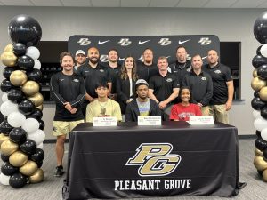 Seniors Ty Boozer, BJ Rochelle, and Lauren Walker sign with their chosen colleges at the signing day ceremony. 