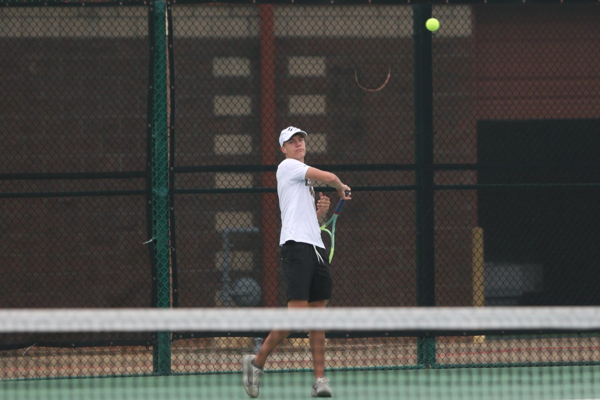 Watching the ball fly, senior Ayres Fuqua anticipates the fall of his serve.