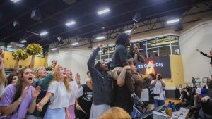 Senior Terrell Pattin rallies the student section during a pep rally.