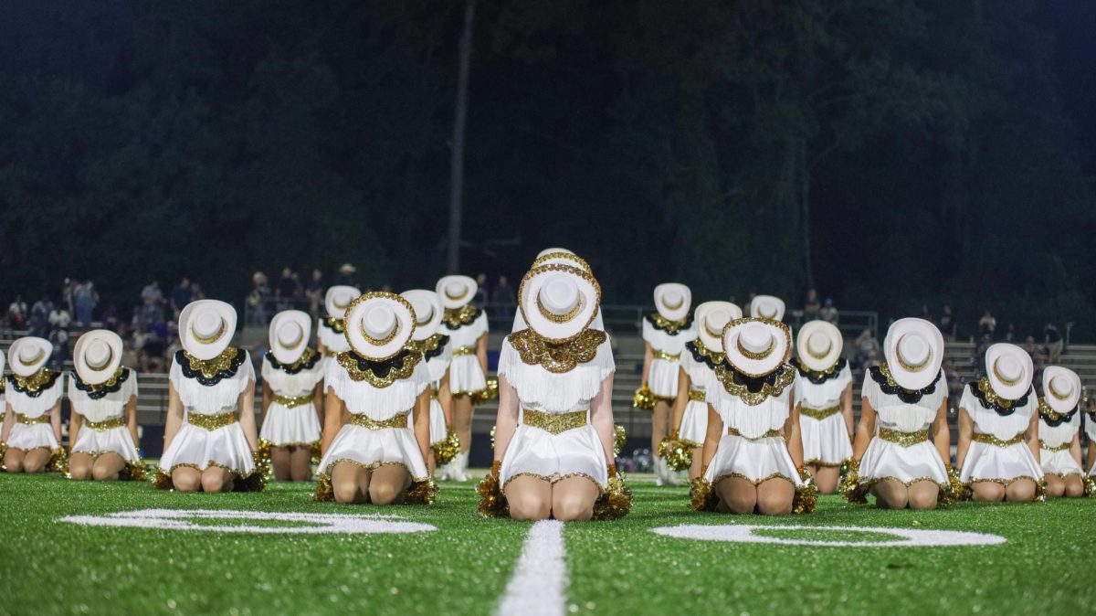 With heads lowered, the Showstoppers prepare to perform their dance to "Hey Ya!"
