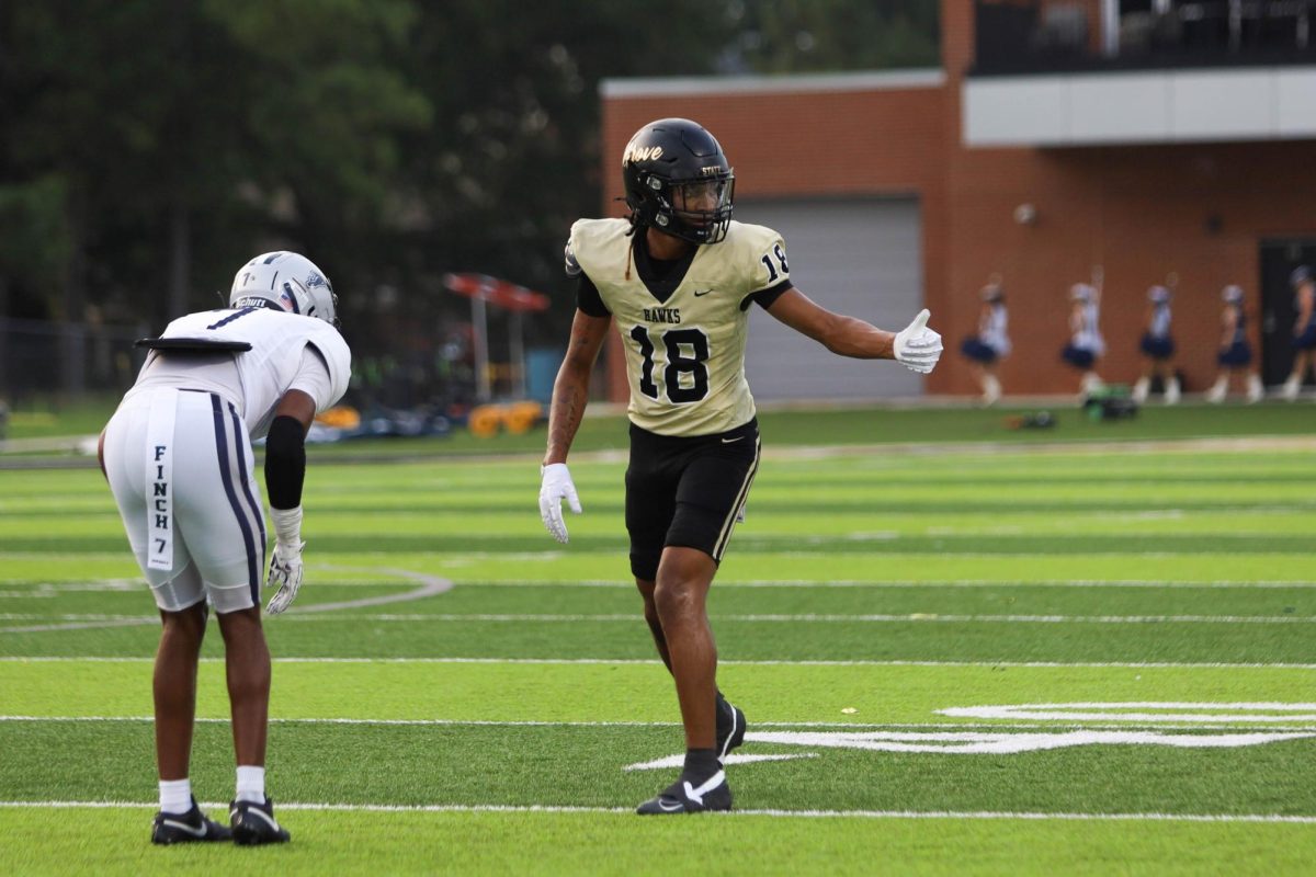 Lining up against the cornerback, senior Bam Harris checks with the referee to make sure he is onside.