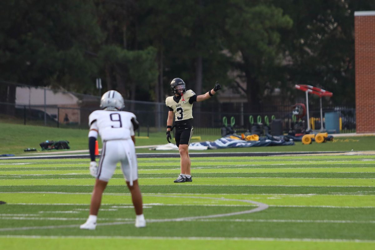 Giving  thumbs up, senior James Solomon signals to his teammates to start the play.